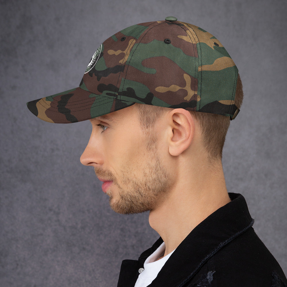 Dad hat in green camo color with curved visor and adjustable strap, modeled by a man.