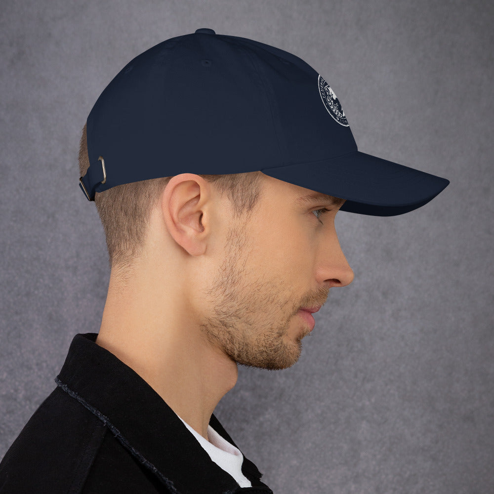 Profile view of a man wearing a navy blue dad hat with an adjustable strap and curved visor.