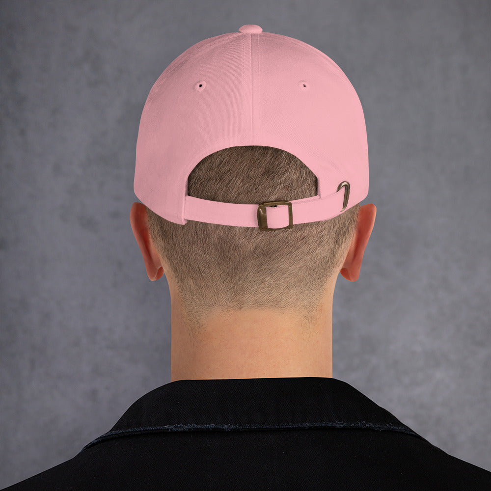 Back view of a pink dad hat with adjustable strap and buckle, showcasing its low-profile design.