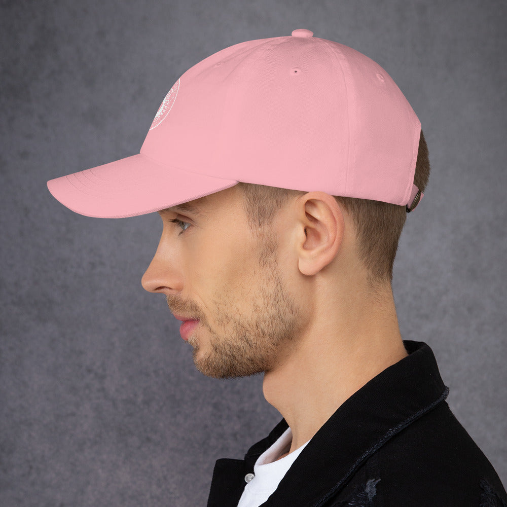 Side view of a man wearing a pink dad hat with a curved visor and adjustable strap.