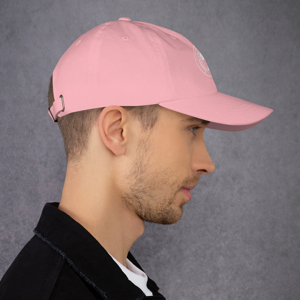 Dad hat in pink color shown on model's head, featuring adjustable strap and curved visor.