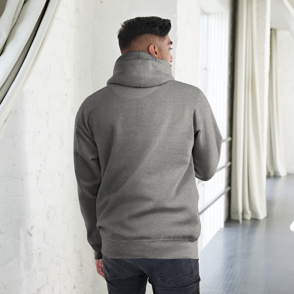 Back view of a man wearing a Unisex Hoodie with a warm hood and stylish design in a modern indoor setting.