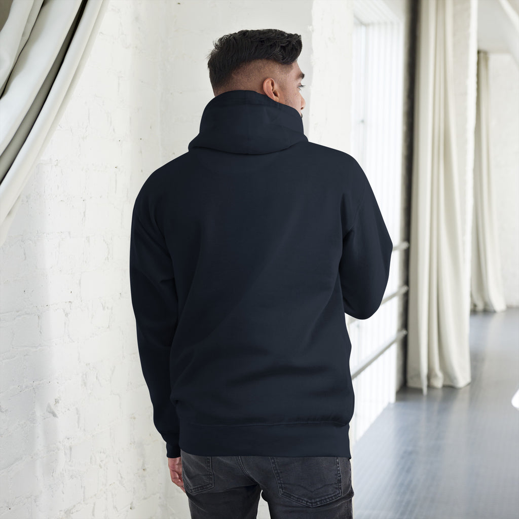 Unisex Hoodie worn from the back in a stylish indoor setting, showcasing its warm hood and soft fabric.