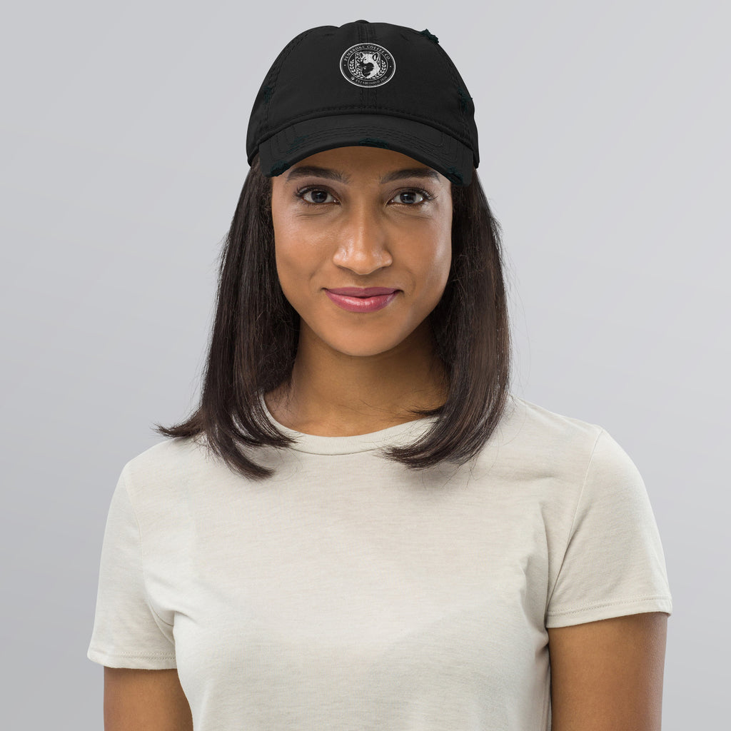 Woman wearing a Distressed Dad Hat in black with a logo, showcasing a stylish look for casual outfits.