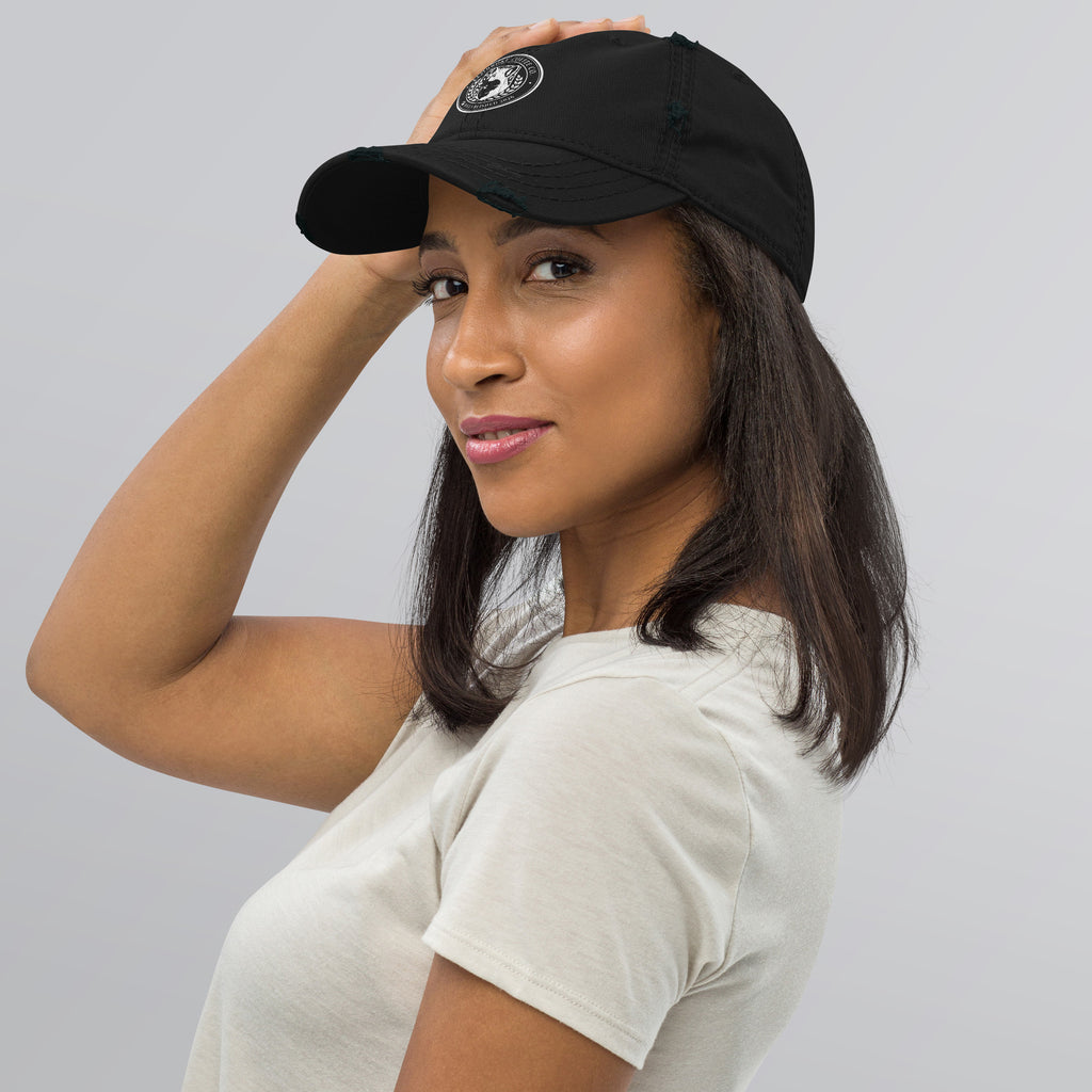 Woman wearing a Distressed Dad Hat with a soft crown and distressed design.