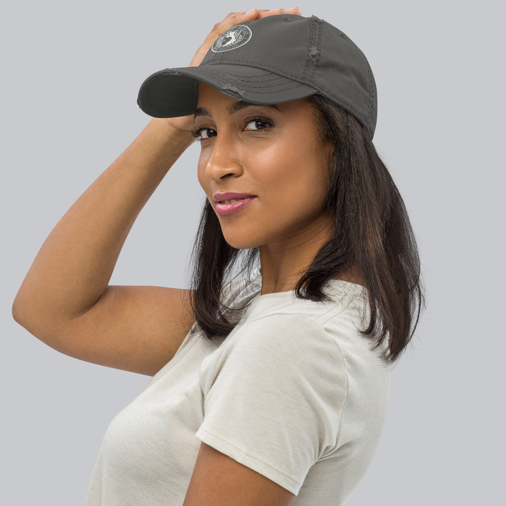 Woman wearing a Distressed Dad Hat, showcasing its stylish design and soft crown fabric.
