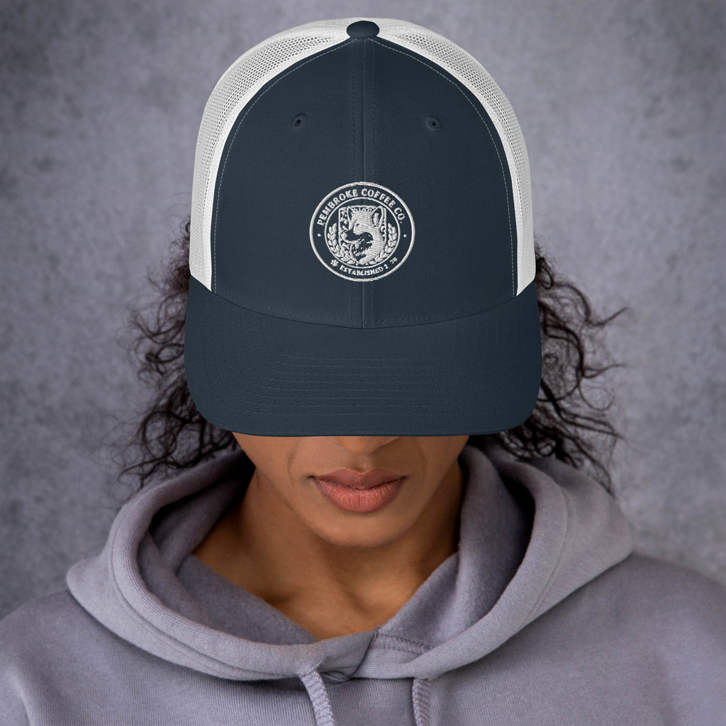 Trucker Cap featuring a logo design, structured six-panel style with mesh back, ideal for sunny days.