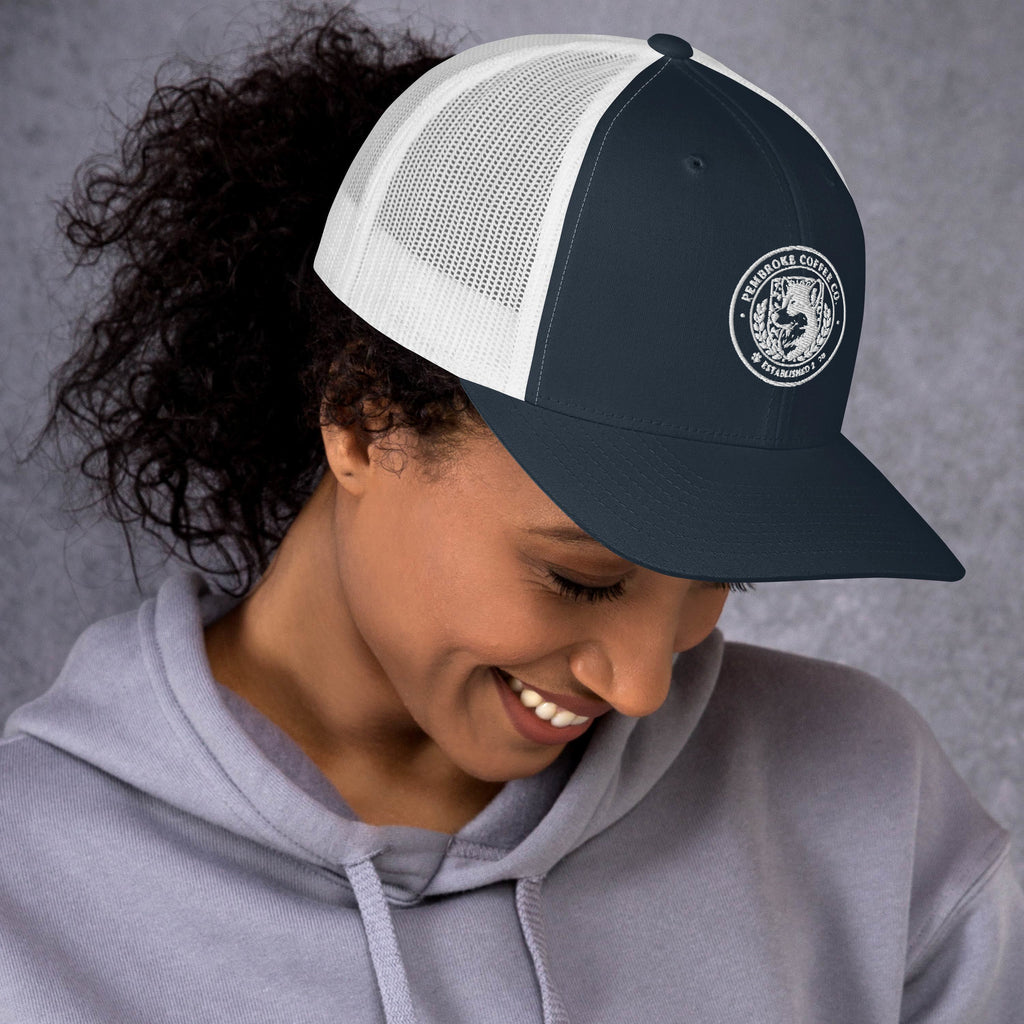Person wearing a stylish Trucker Cap with mesh back, perfect for sunny outdoor days.