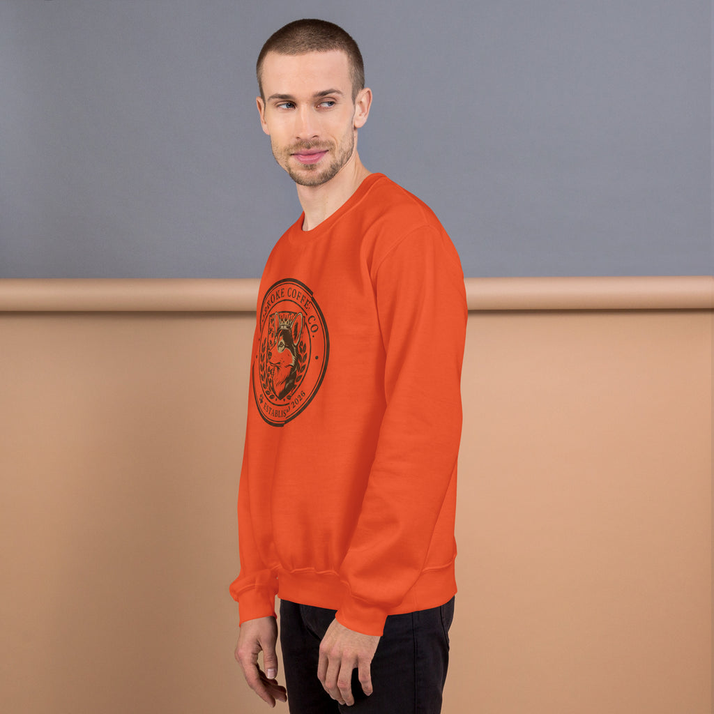 Model wearing an orange Unisex Sweatshirt with a bold graphic design, perfect for colder weather.