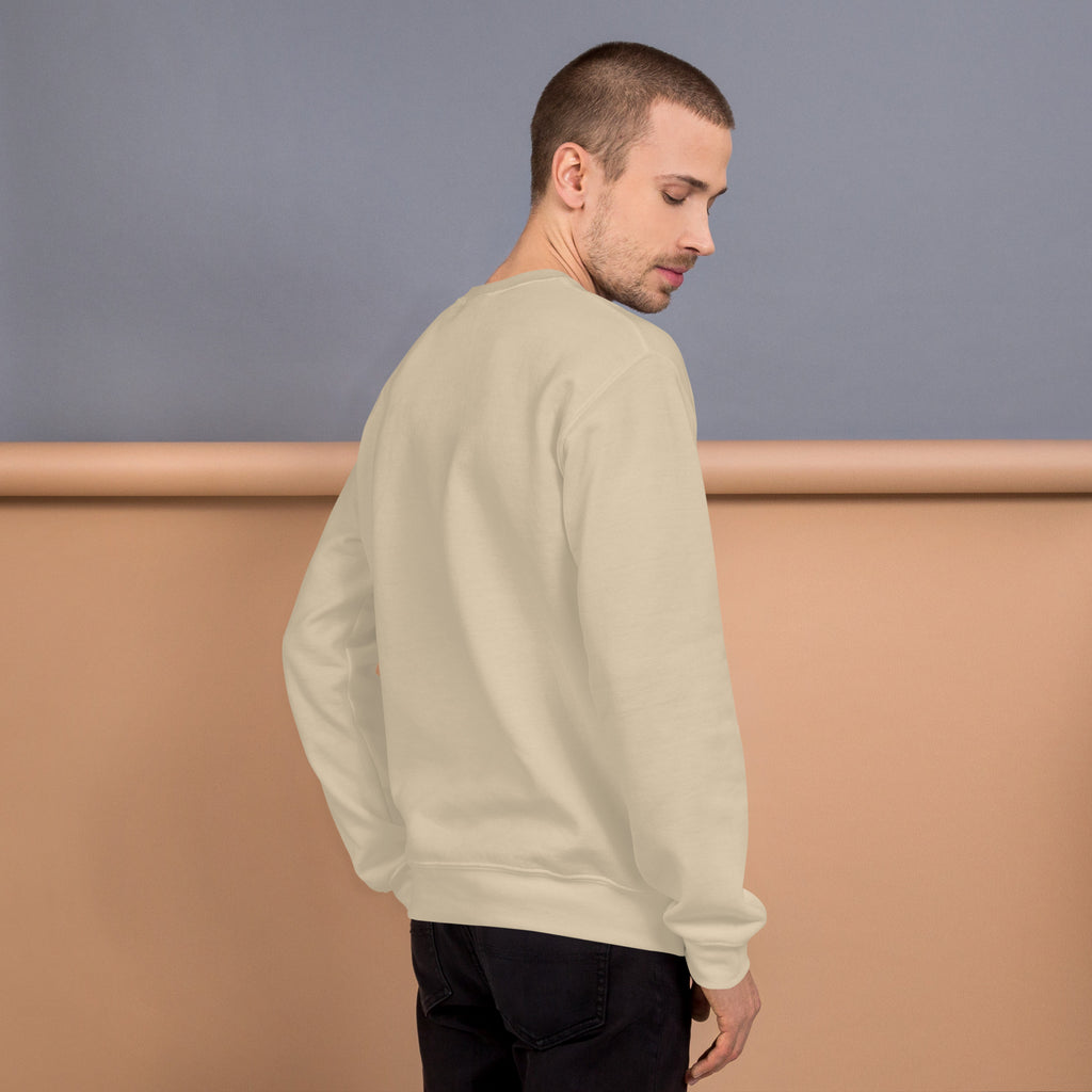 Back view of a model wearing a Unisex Sweatshirt in a soft beige color against a pastel background.
