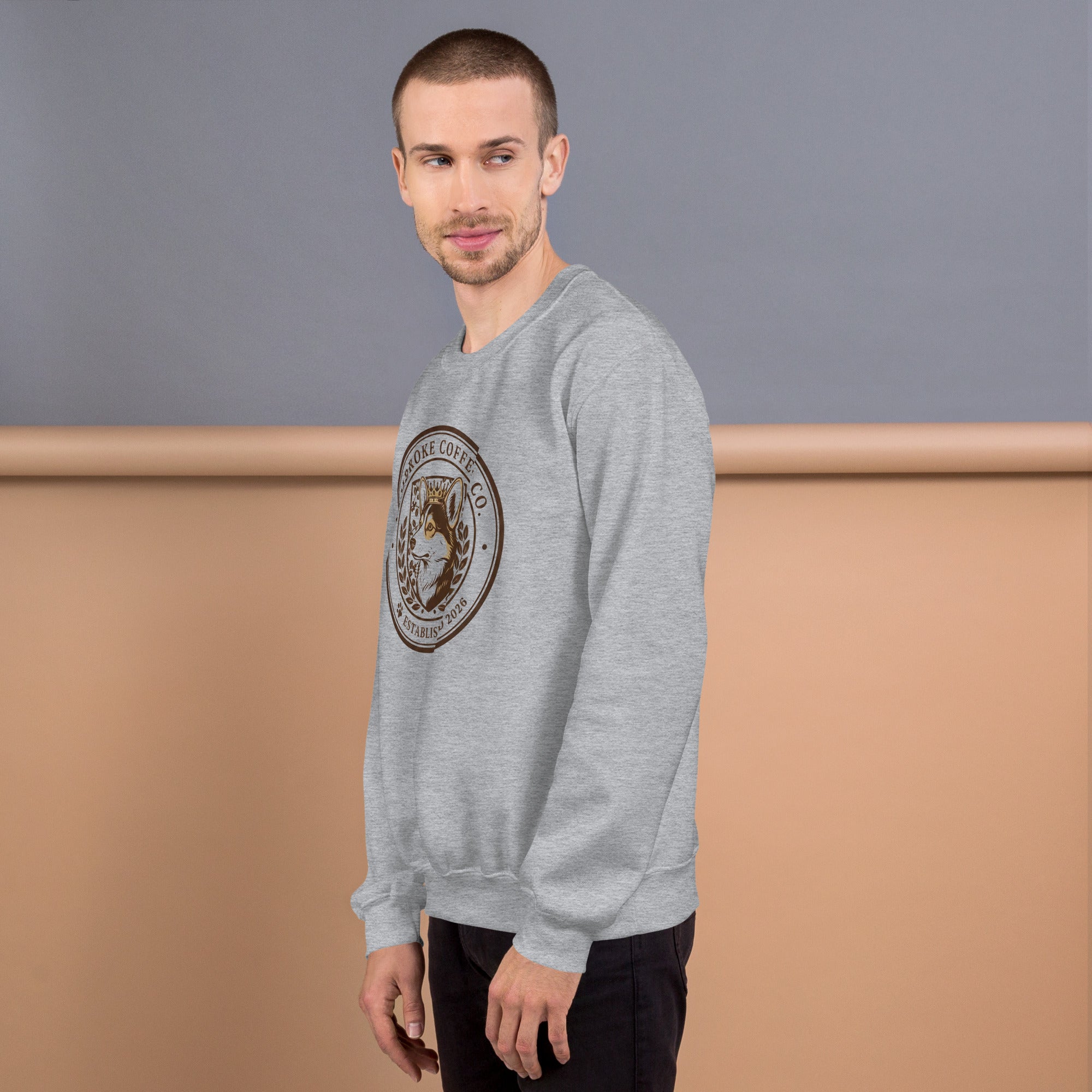 Man wearing a Unisex Sweatshirt with a circular logo design in gray color, perfect for colder months.