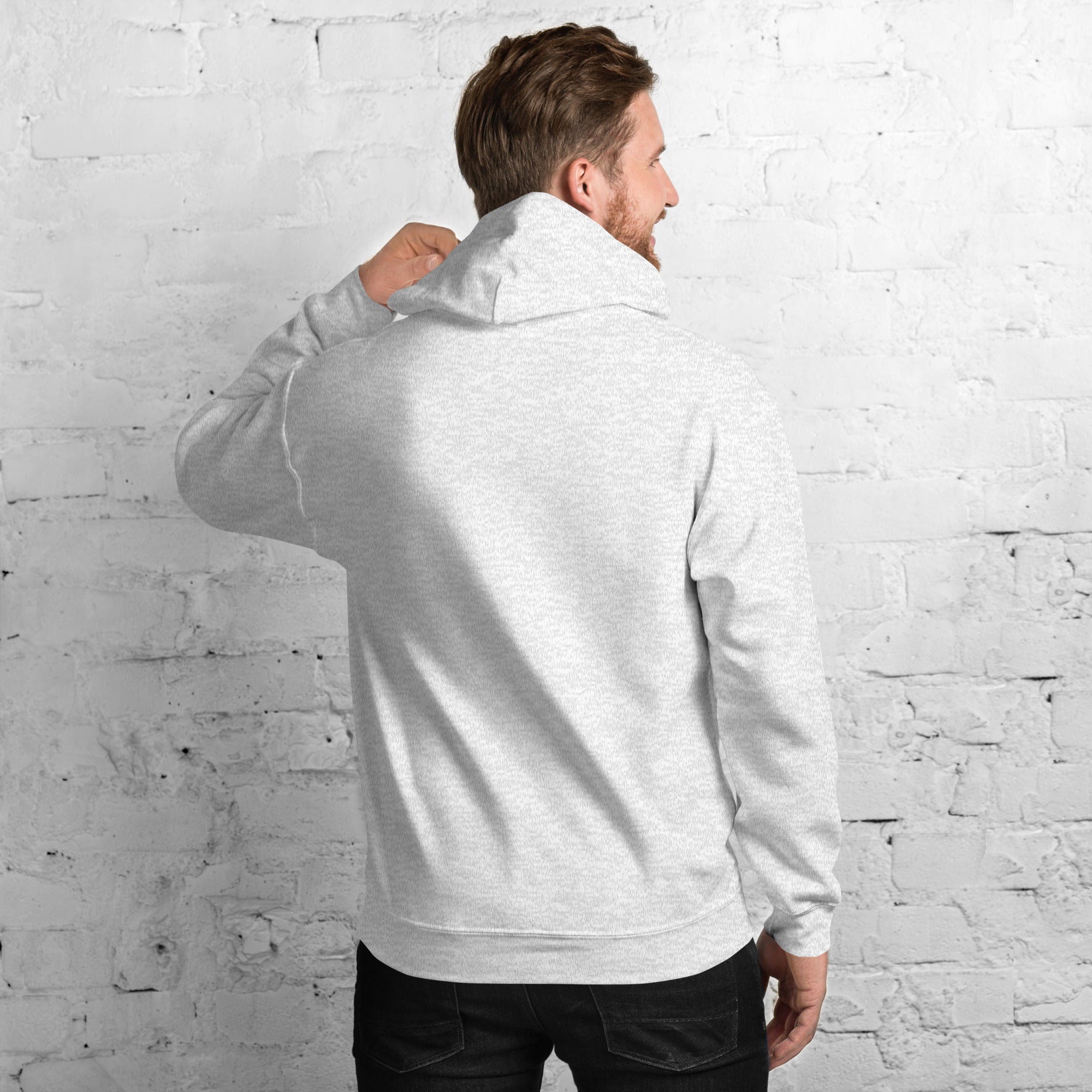 A man wearing a soft, stylish Unisex Hoodie in grey, showcasing the double-lined hood and relaxed fit.