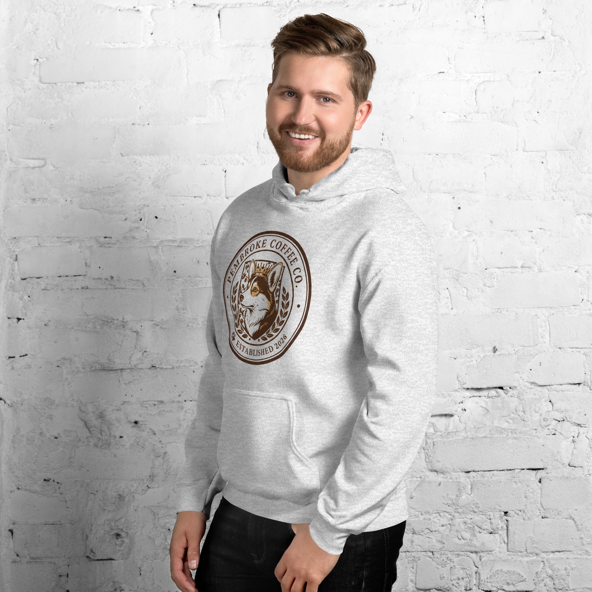 Man wearing a stylish Unisex Hoodie with a coffee logo, perfect for cozy evenings.
