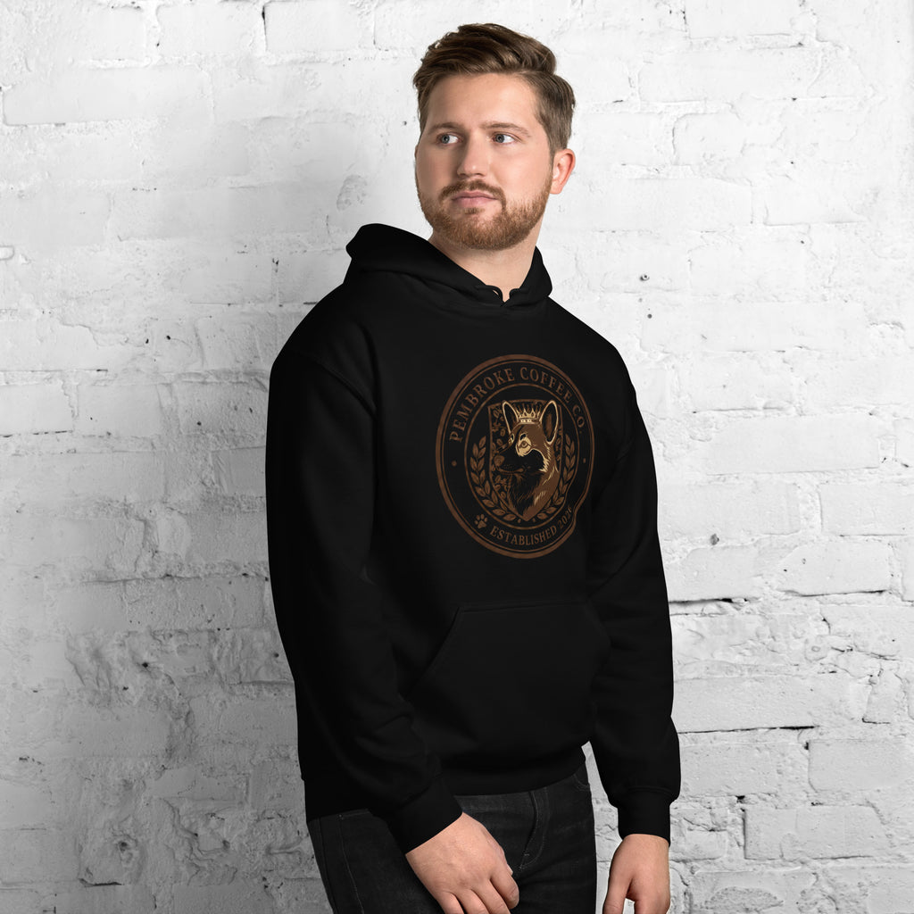 A man wearing a stylish Unisex Hoodie with a coffee-themed graphic, perfect for cozy wear.