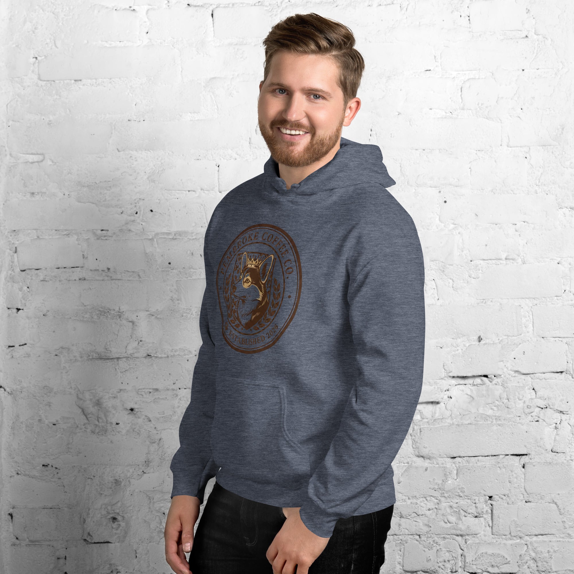Unisex Hoodie featuring a stylish design, worn by a smiling man against a brick wall background.