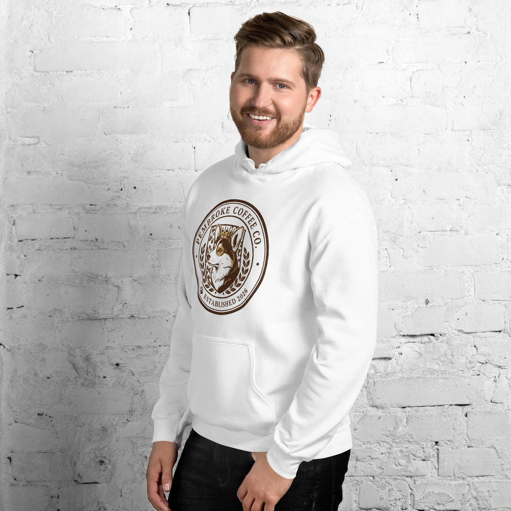 Man wearing a white Unisex Hoodie with logo, standing against a brick wall, showcasing a cozy and stylish sporty look.
