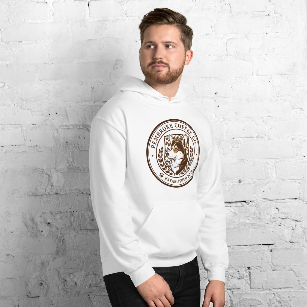 Unisex Hoodie featuring a logo design, worn by a man against a brick wall backdrop.