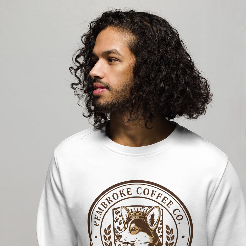 Young man wearing a Unisex organic sweatshirt with Pembroke Coffee Co. logo, featuring soft, eco-friendly materials.