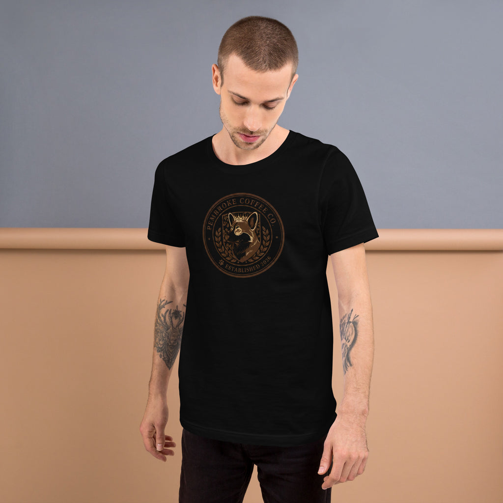 Man wearing a black unisex t-shirt with a logo design, showcasing comfort and style in a casual setting.