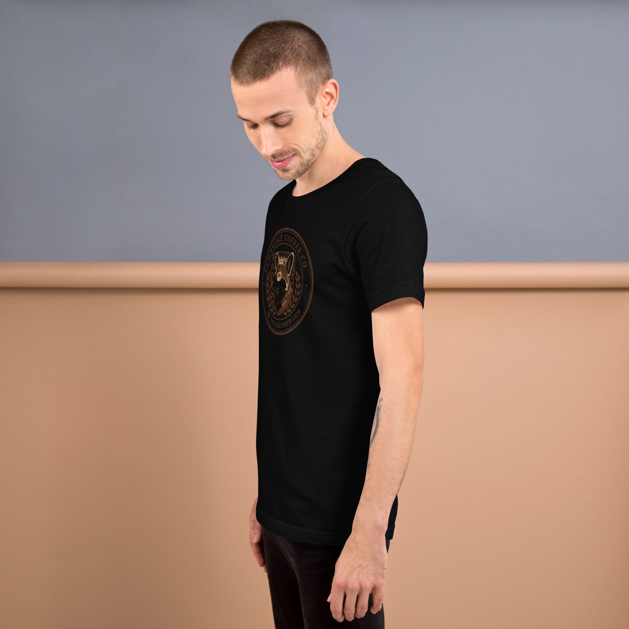 Unisex t-shirt worn by a man, showcasing a stylish black design with a graphic print.
