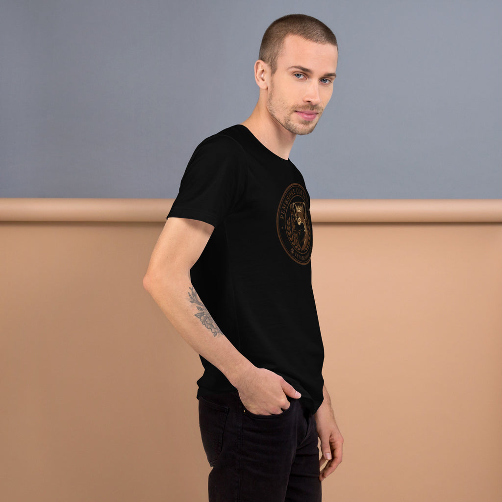 Man wearing a black unisex t-shirt with a logo, showcasing its soft and comfortable fabric.