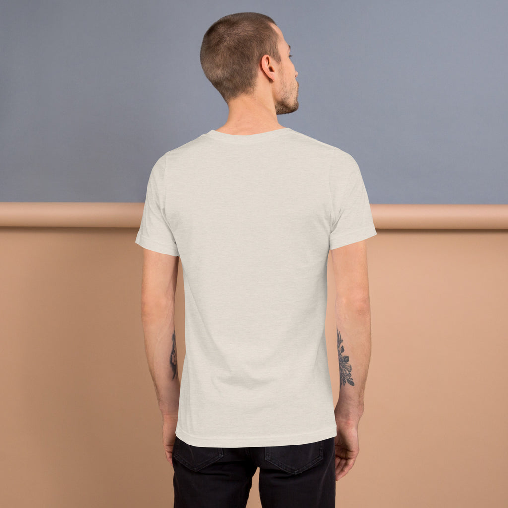Back view of a man wearing a soft and lightweight Unisex t-shirt against a muted background.