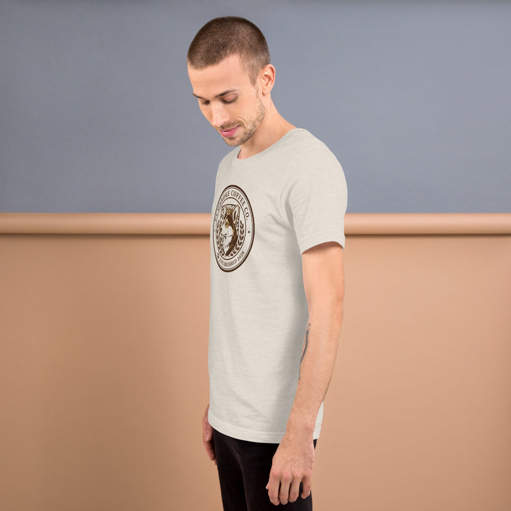 Unisex t-shirt displayed on a model, featuring a circular logo design in a light fabric.