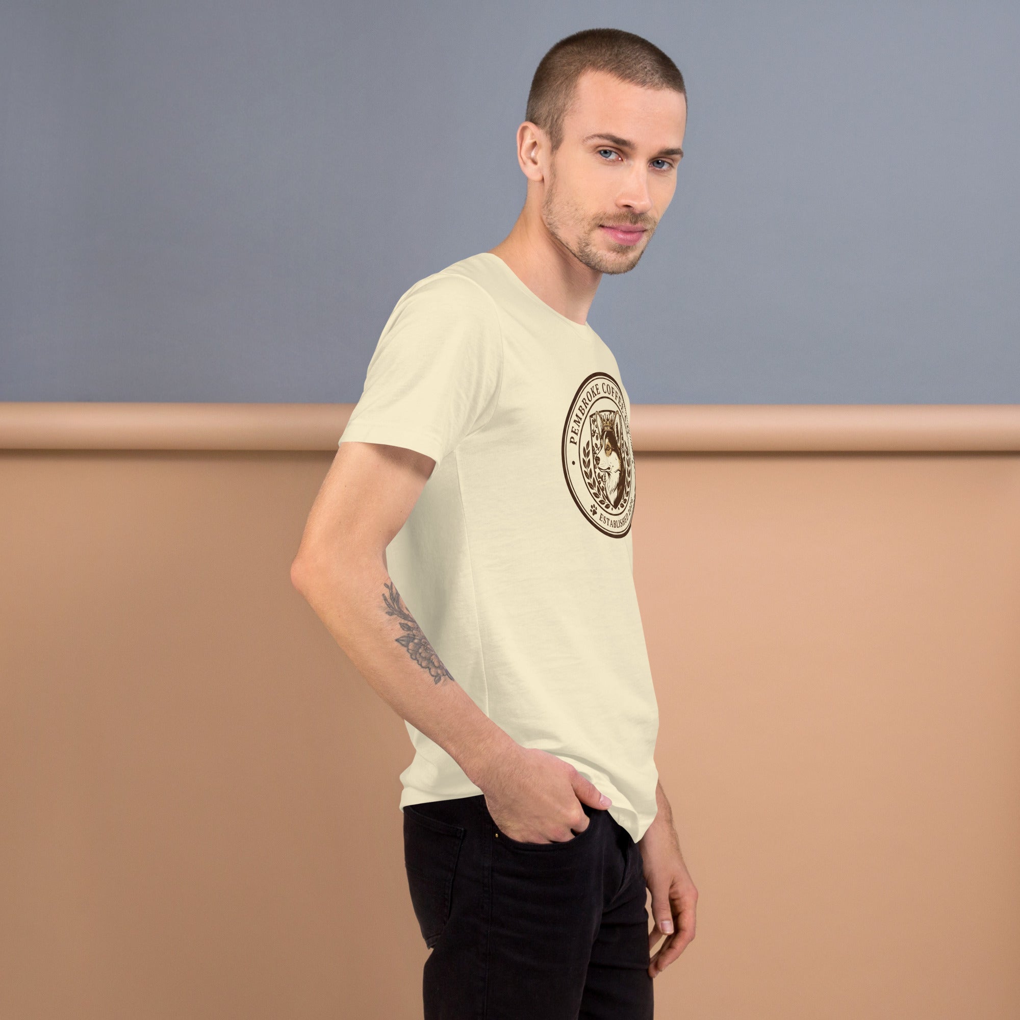 Unisex t-shirt modeled by a man, showcasing a comfortable fit and stylish design against a pastel background.