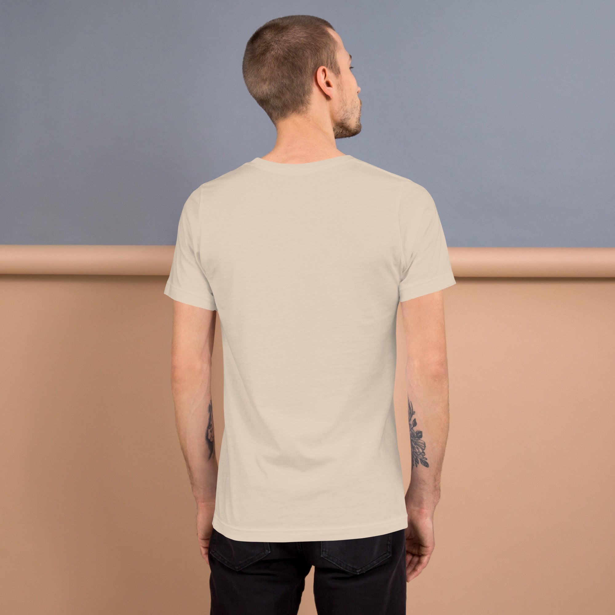 Back view of a man wearing a soft, lightweight unisex t-shirt in a neutral color.