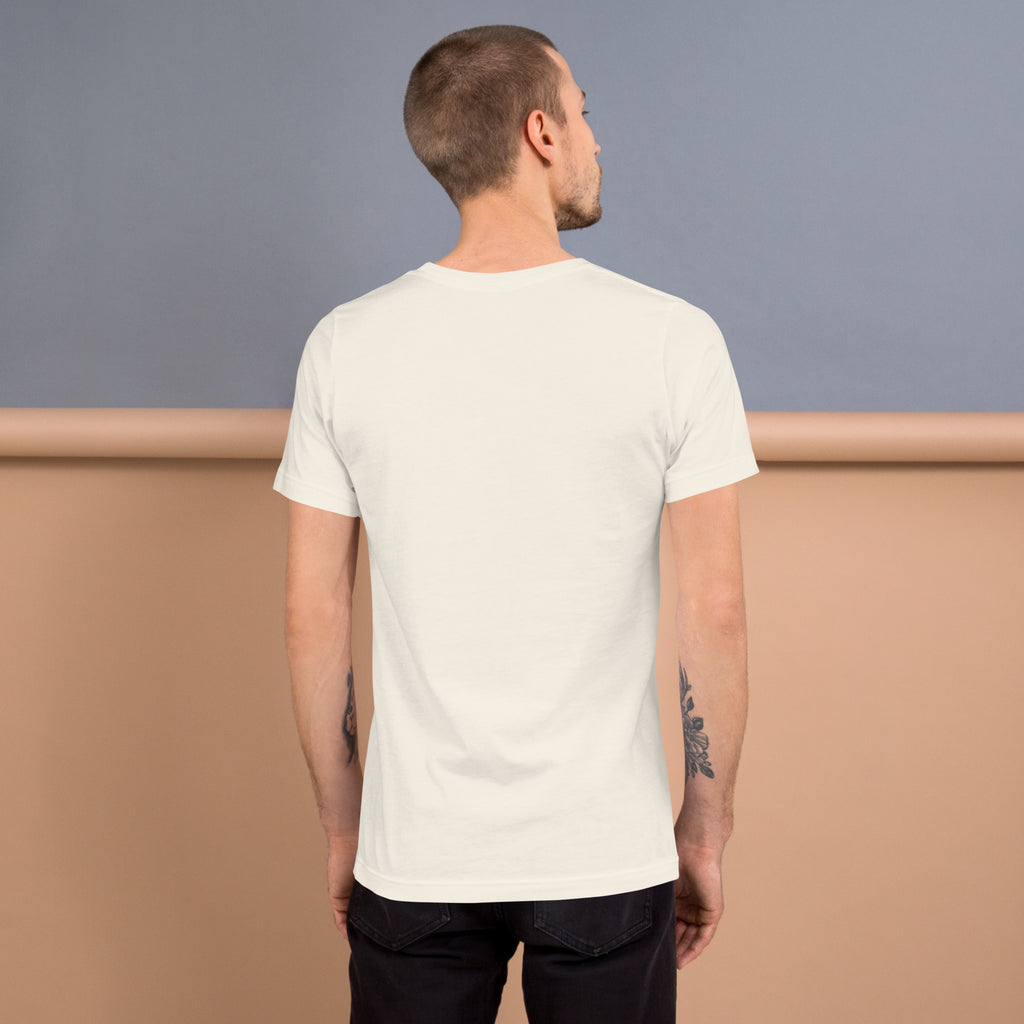Back view of a model wearing a soft, lightweight Unisex t-shirt in neutral color against a light backdrop.